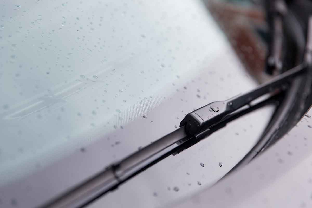 close up of windshield wiper and wet car glass WindscreenRepair